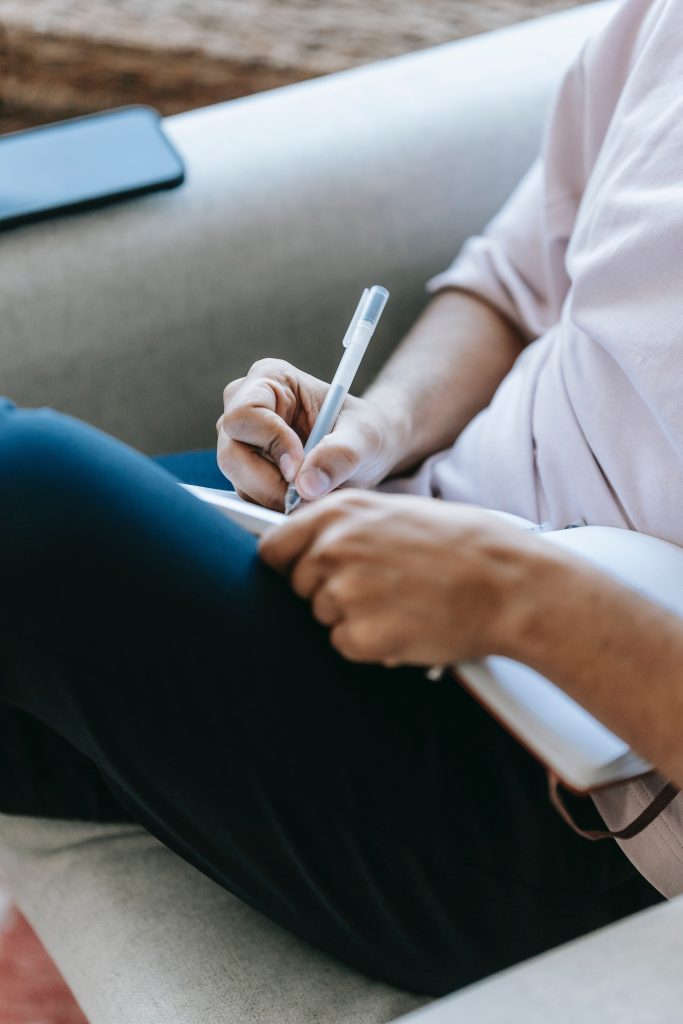 Person writing on tablet