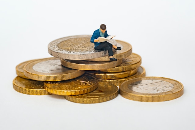 Man sitting on a stack of gold coins